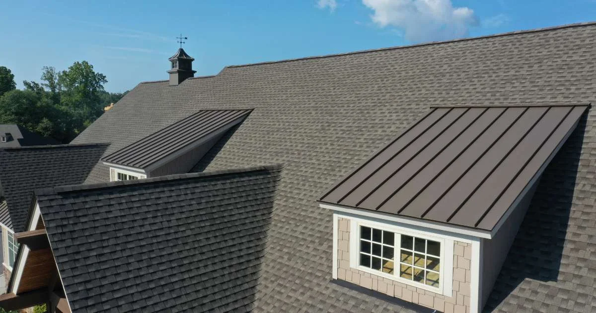 A rooftop with a combination of asphalt shingles and standing seam metal roofing, blending traditional and modern styles.